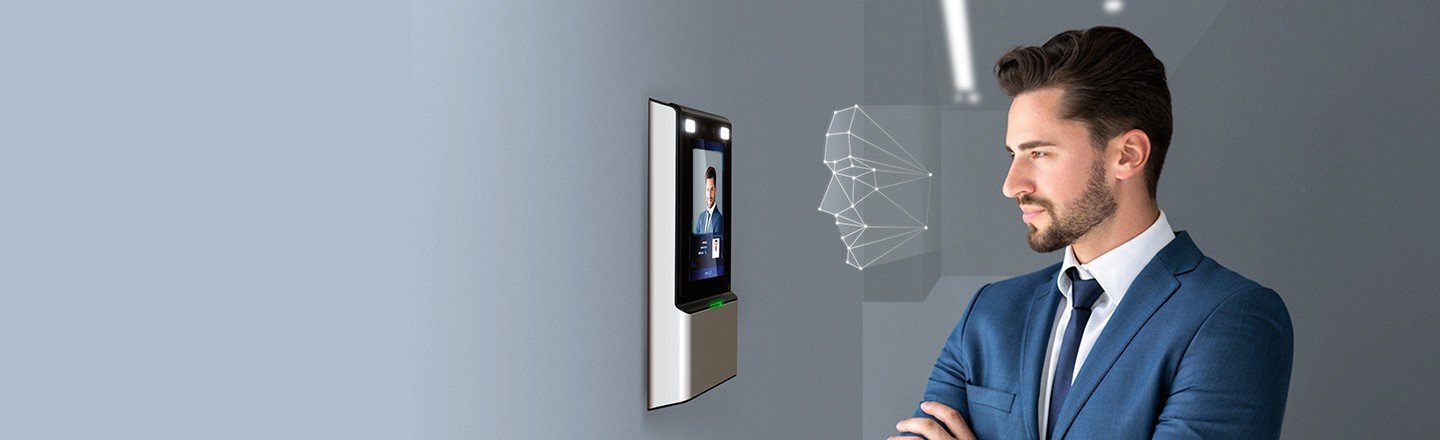 Hikvision face recognition terminal in use on a wall-mounted access point